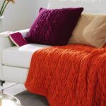 orange bedspread and pillow