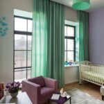 mint curtains with brown armchair