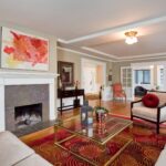 living room with a painting above the fireplace