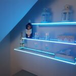 glass shelves on the wall with illuminated photo