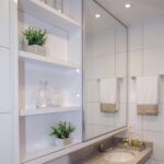 built-in wardrobe in the bathroom above the sink