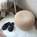 knitted pouf white by the bed