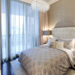 beige curtains in the bedroom with blue tulle