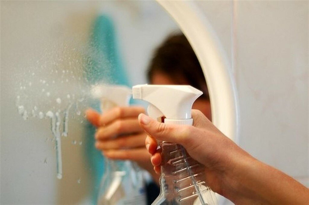 cleaning the bathroom mirror