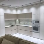 kitchen cabinets up to the ceiling with lamps