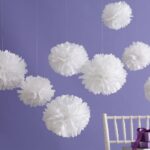 white napkin pom-poms hanging