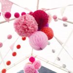 pom-poms from napkins under the ceiling pink