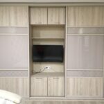 wooden wardrobe in the living room with TV