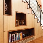 cabinet under the stairs with vases