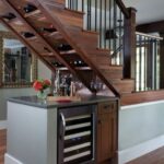 cabinet under the stairs with a bar