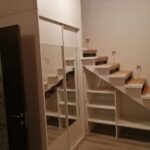 wardrobe under the stairs with mirror and shelves