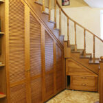 wooden brown cabinet under the stairs