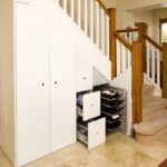 white wardrobe under the stairs