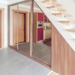 mirrored cabinet under the stairs