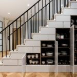 cupboard under the stairs with dishes