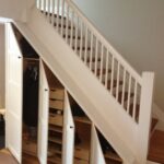 white wardrobe under the stairs with doors