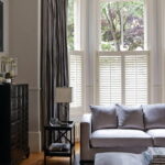 curtains to the windowsill in the bedroom design photo