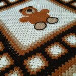 Tunisian knit carpet with a bear