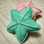 pillow on knitting needles star green