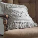 fringed knitting cushion