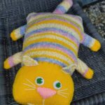 pillow on knitting needles cat