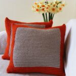 pillow on knitting needles gray