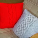 pillow on knitting needles red and white