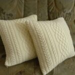 pillow on knitting needles cream