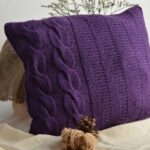 pillow on knitting needles purple