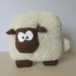 pillow on knitting needles sheep