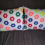 pillow on knitting needles with flowers