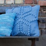 pillow on knitting needles blue with flower