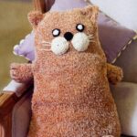 pillow on knitting needles cat brown