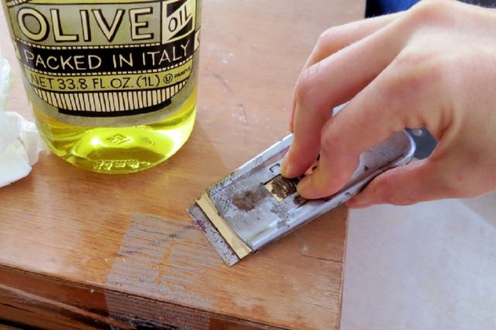 removing adhesive tape with oil