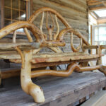 a bench near a house made of wood